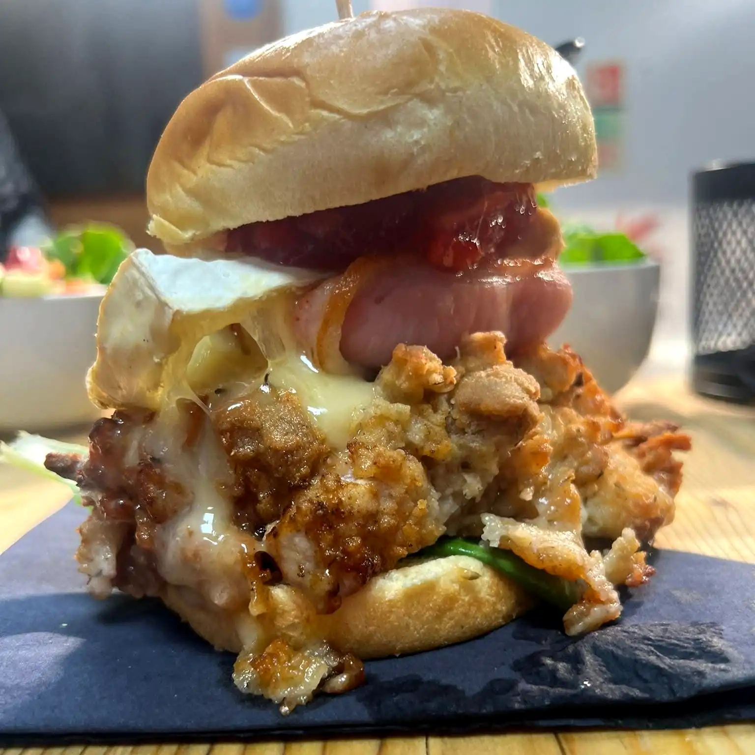A close up of a burger in a bun.