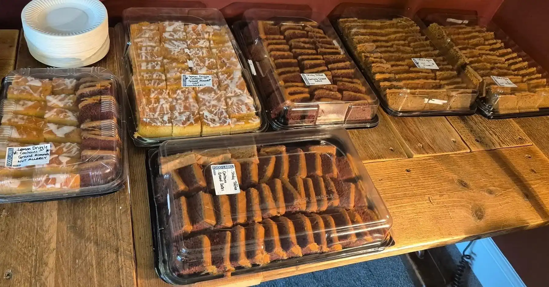 Selection of cakes covered in cling film