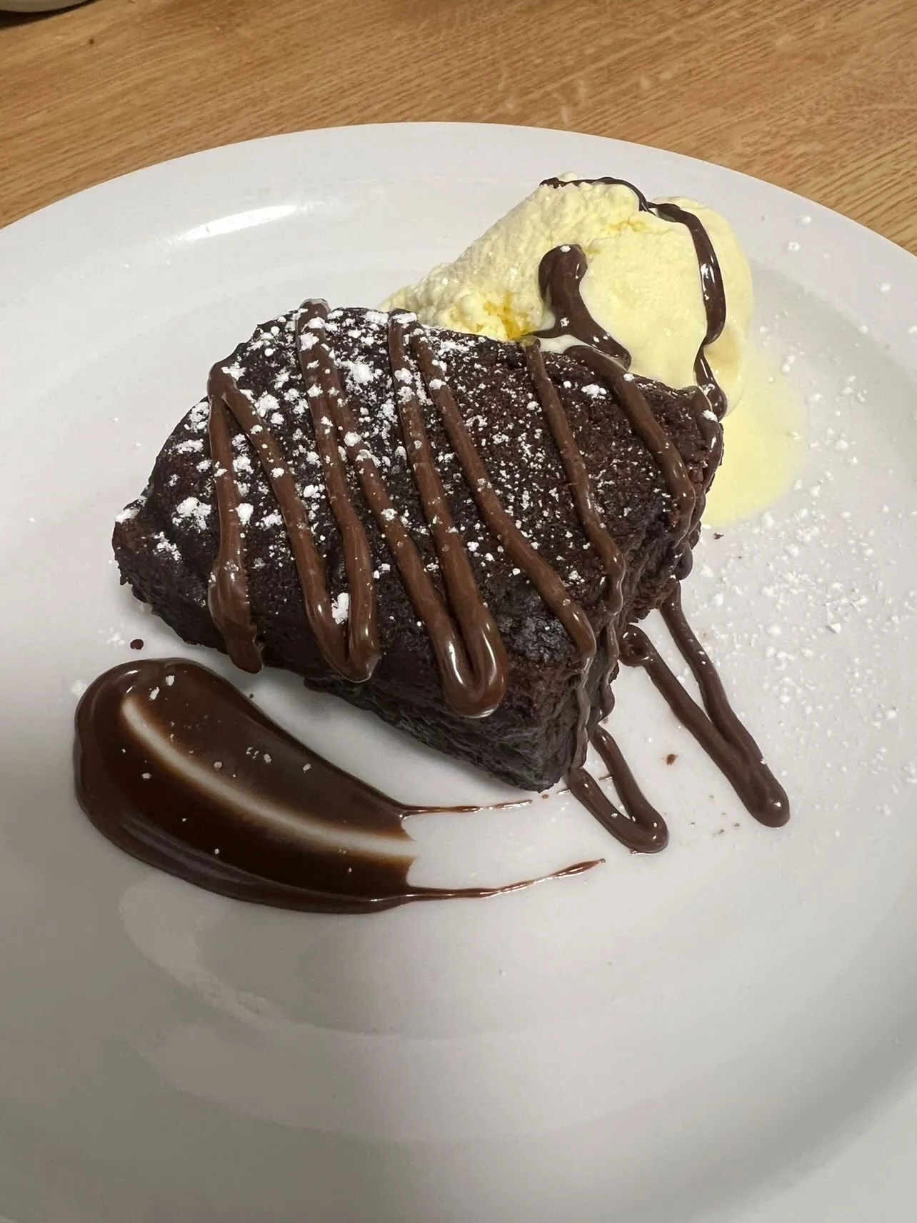 A piece of chocolate cake and ice cream.