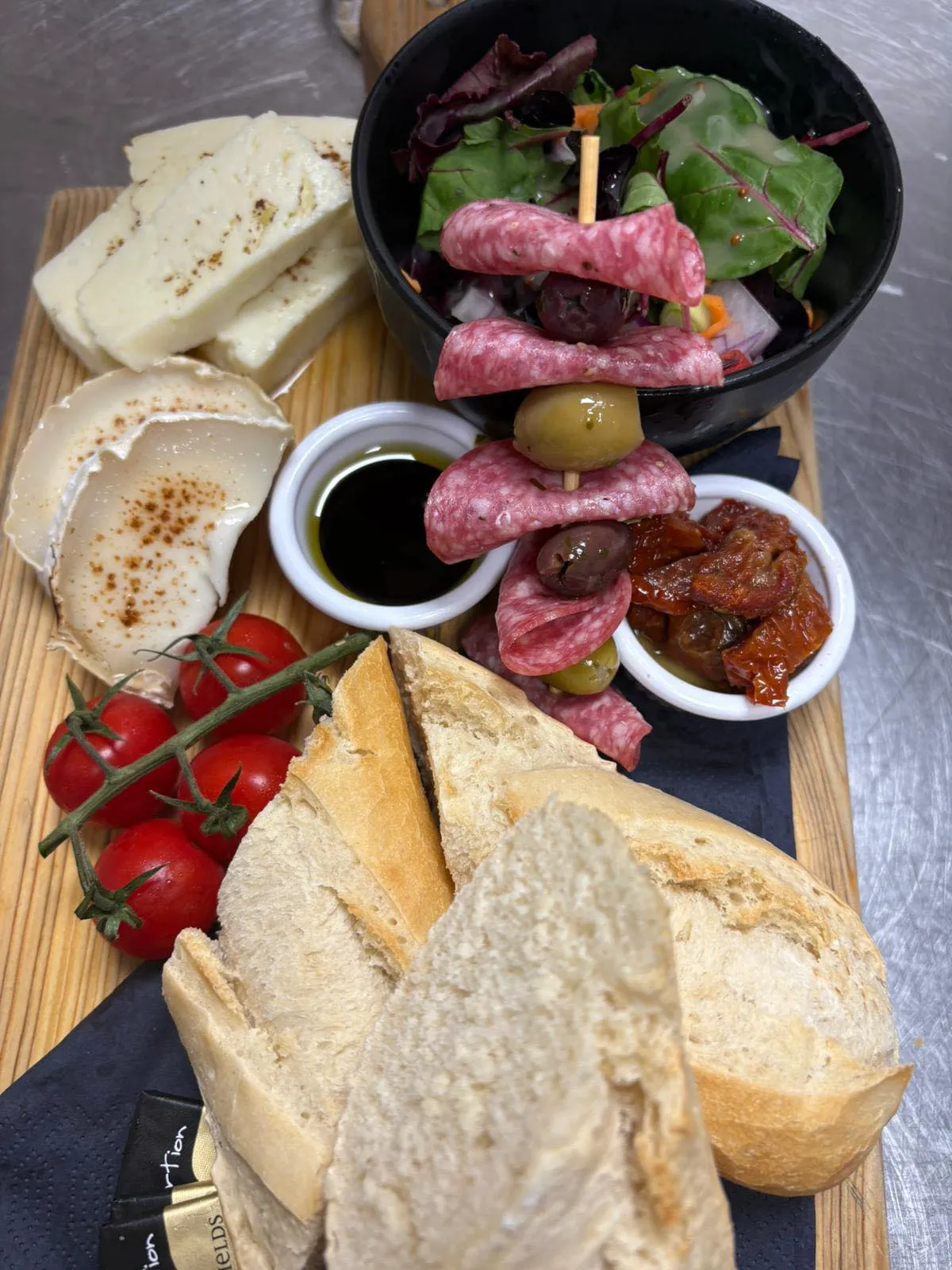 A wooden cutting board topped with lots of food.