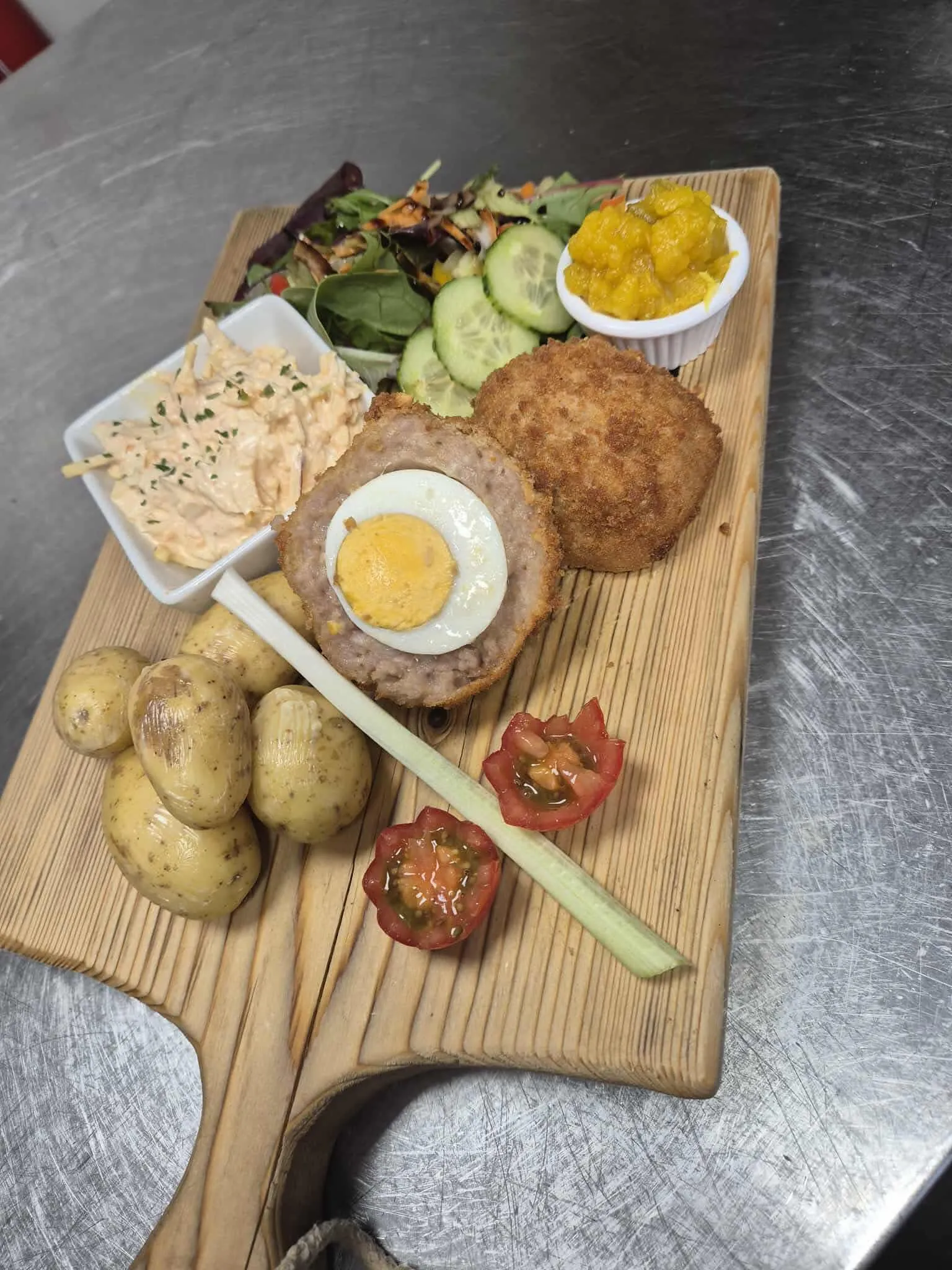 A wooden cutting board topped with different types of food.
