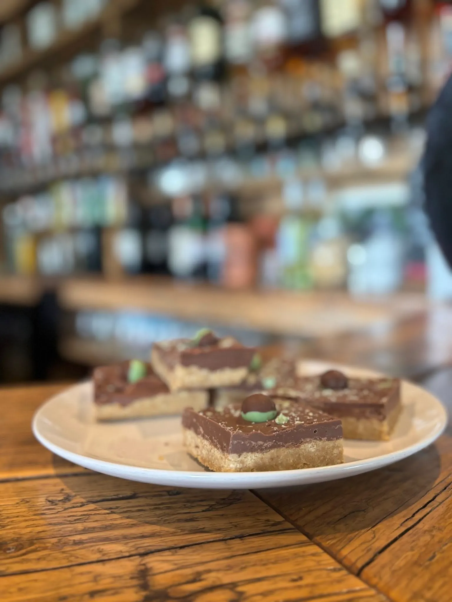 A white plate topped with pieces of chocolate shortbread.