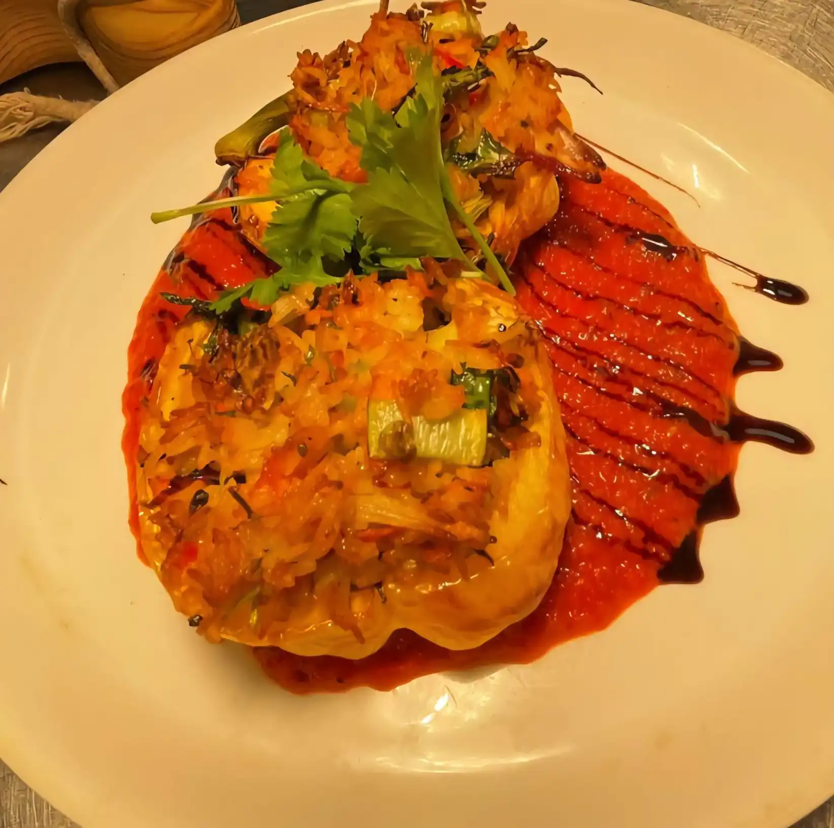 A white plate topped with meat covered in sauce.