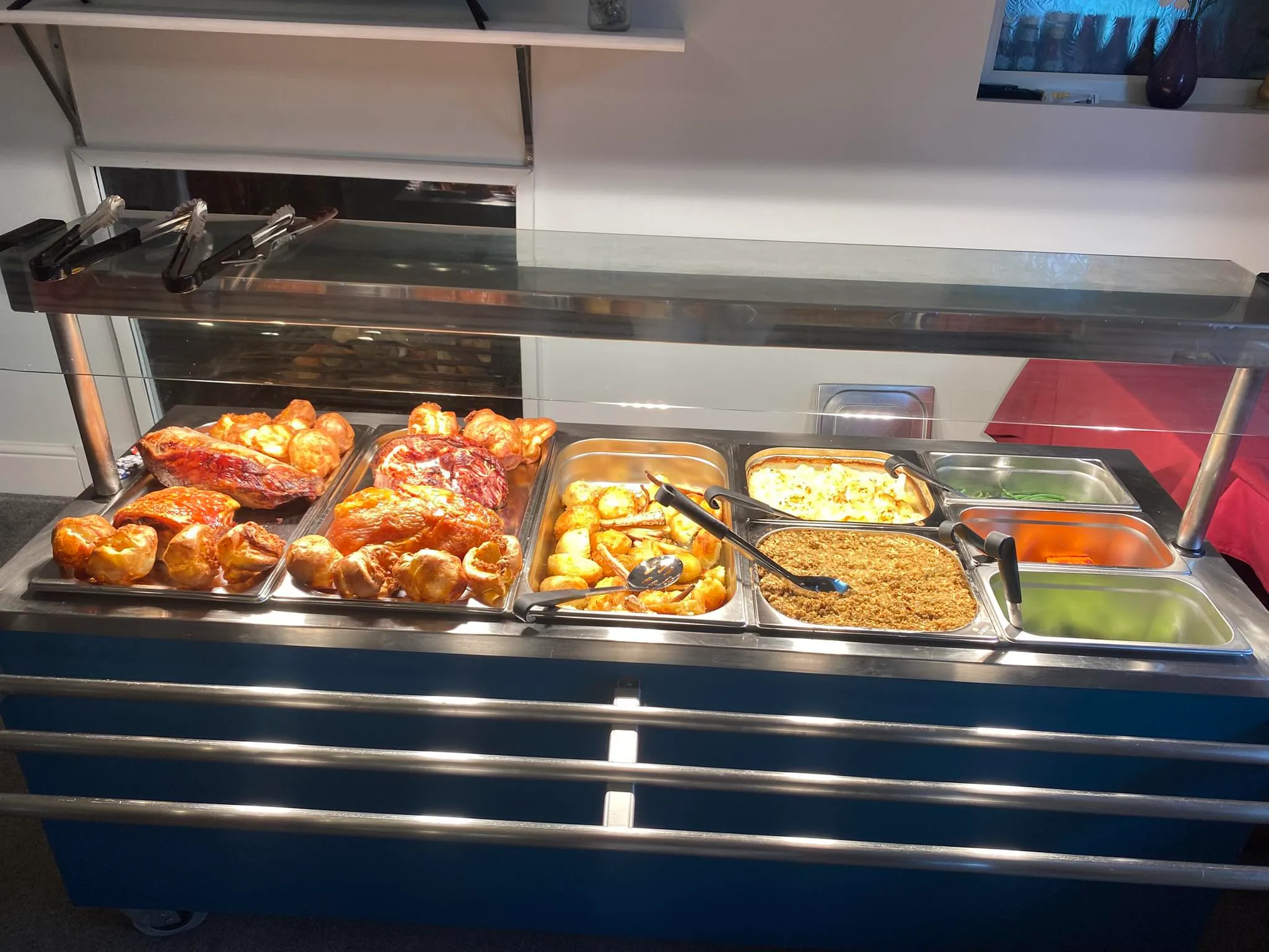 A buffet with a variety of food on it.