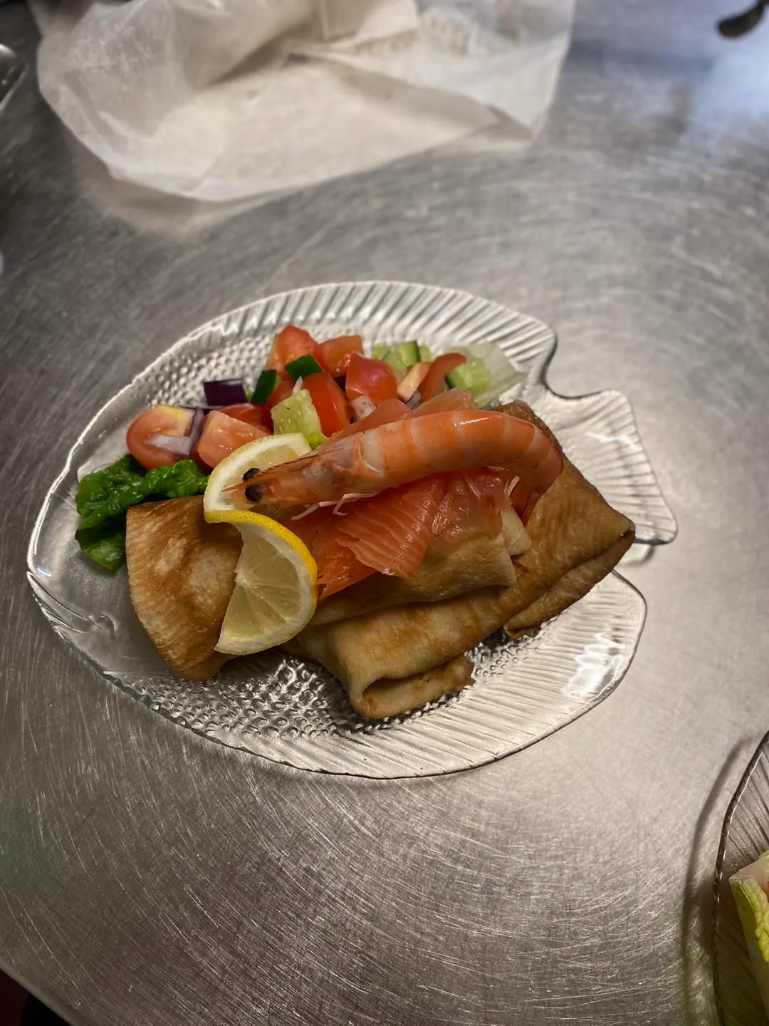 A plate of food on a metal table.