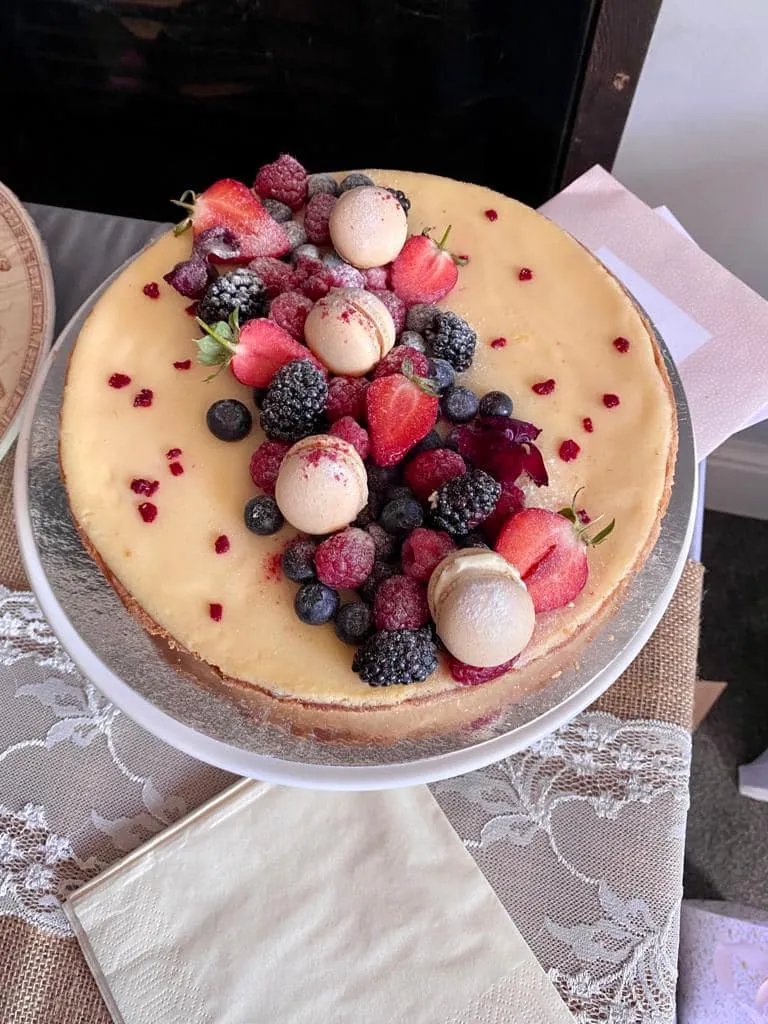 A cheesecake topped with blackberries, strawberries and raspberries.