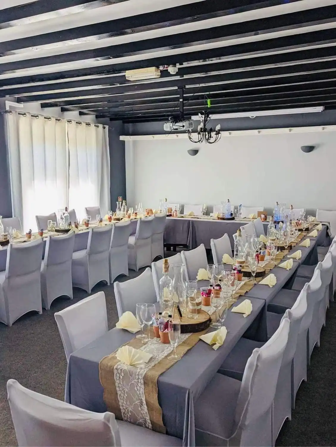 A banquet room with tables and chairs set up for a formal function.